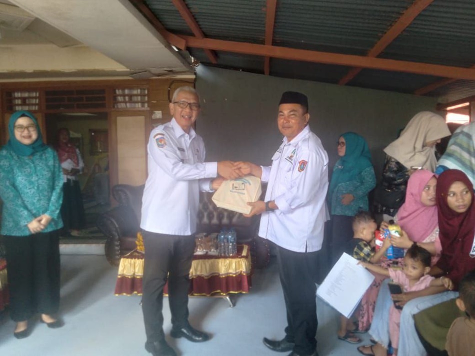 Pj Gubernur Gorontalo menyerahkan bantuan usai peresmian rumah sehat (F:humas)