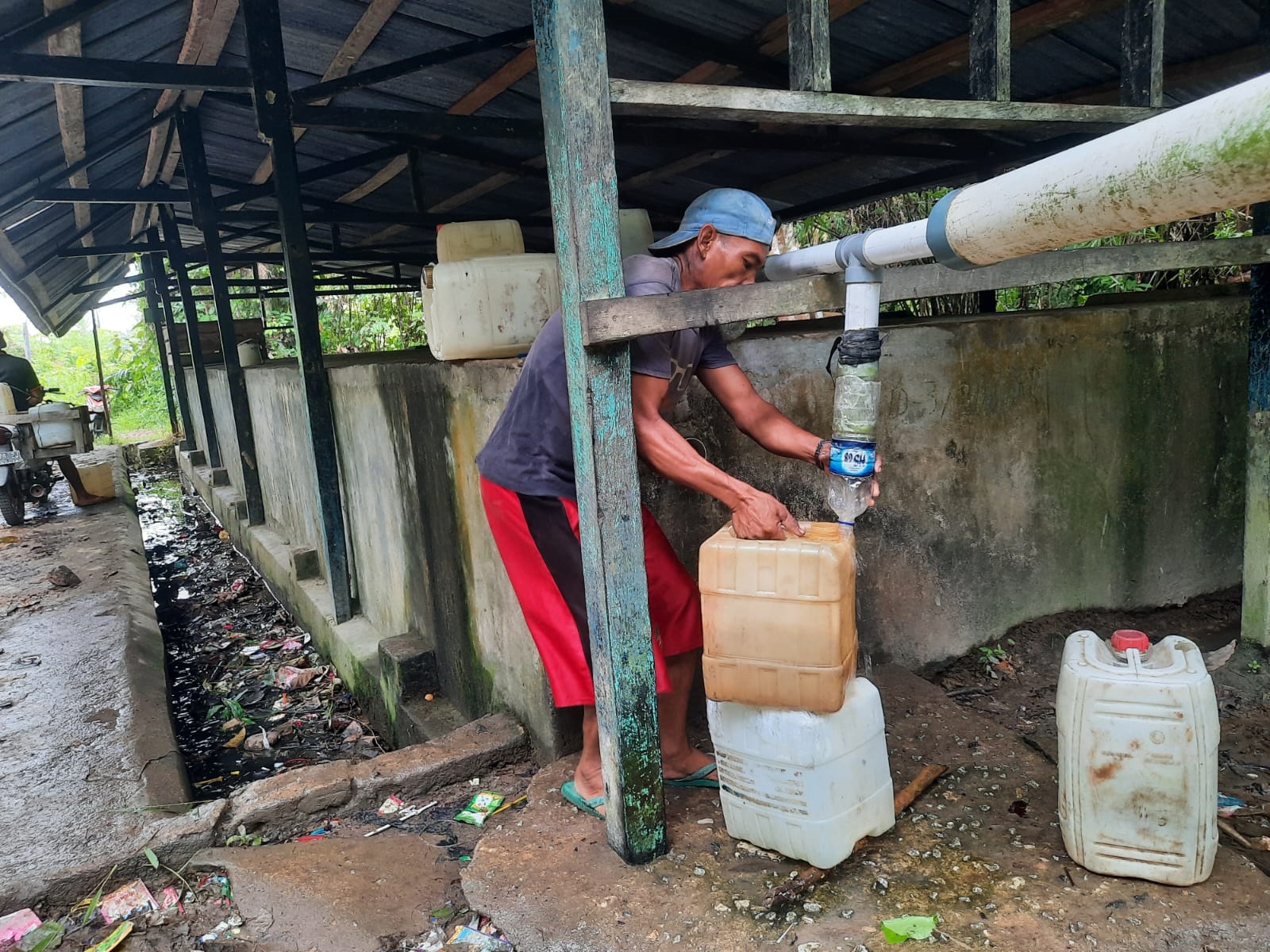 PENGAMBILAN AIR : Warga sedang mengambil air bersih di di Desa Alur Bandung, Kecamatan Teluk Batang. ISTIMEWA