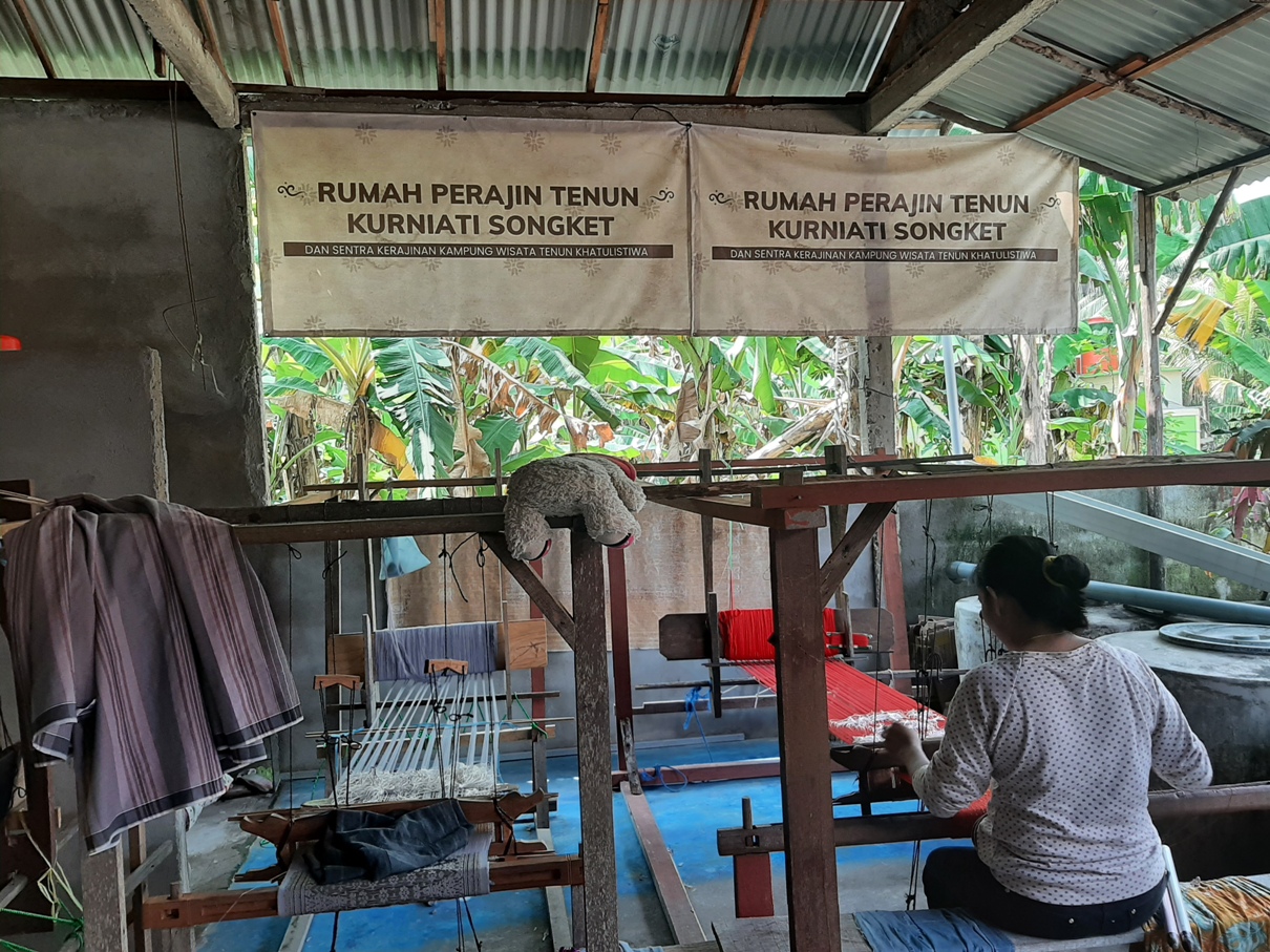 Salah satu perajin di Rumah Tenun Kurniati Songket sedang asyik menenun.