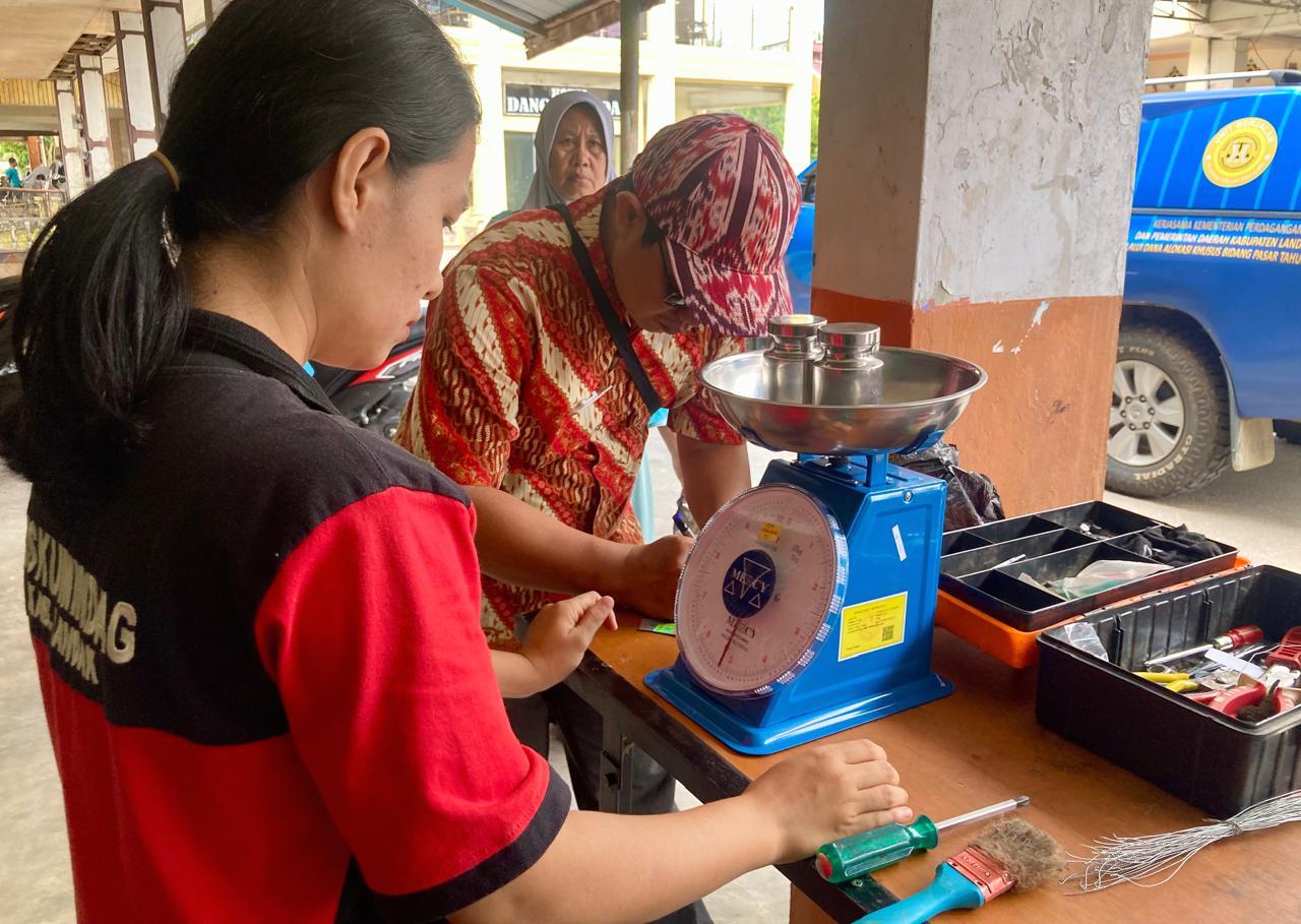 CEK TIMBANGAN: Petugas Disperindagkop Kabupaten Landak saat melakukan memeriksa timbangan milik pedagang Pasar Pagi Ngabang, Kamis (25/7).