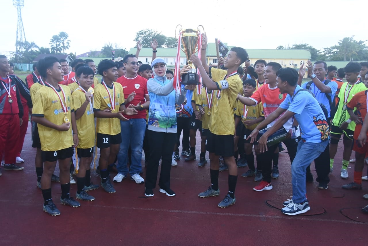 JUARA: Kepala Dinas Pendidikan dan Kebudayaan Provinsi Kalimantan Barat, Rita Hastarita, menyerahkan piala kemenangan pada Tim Sepak Bola Gala Siswa Indonesia Kabupaten Sambas.