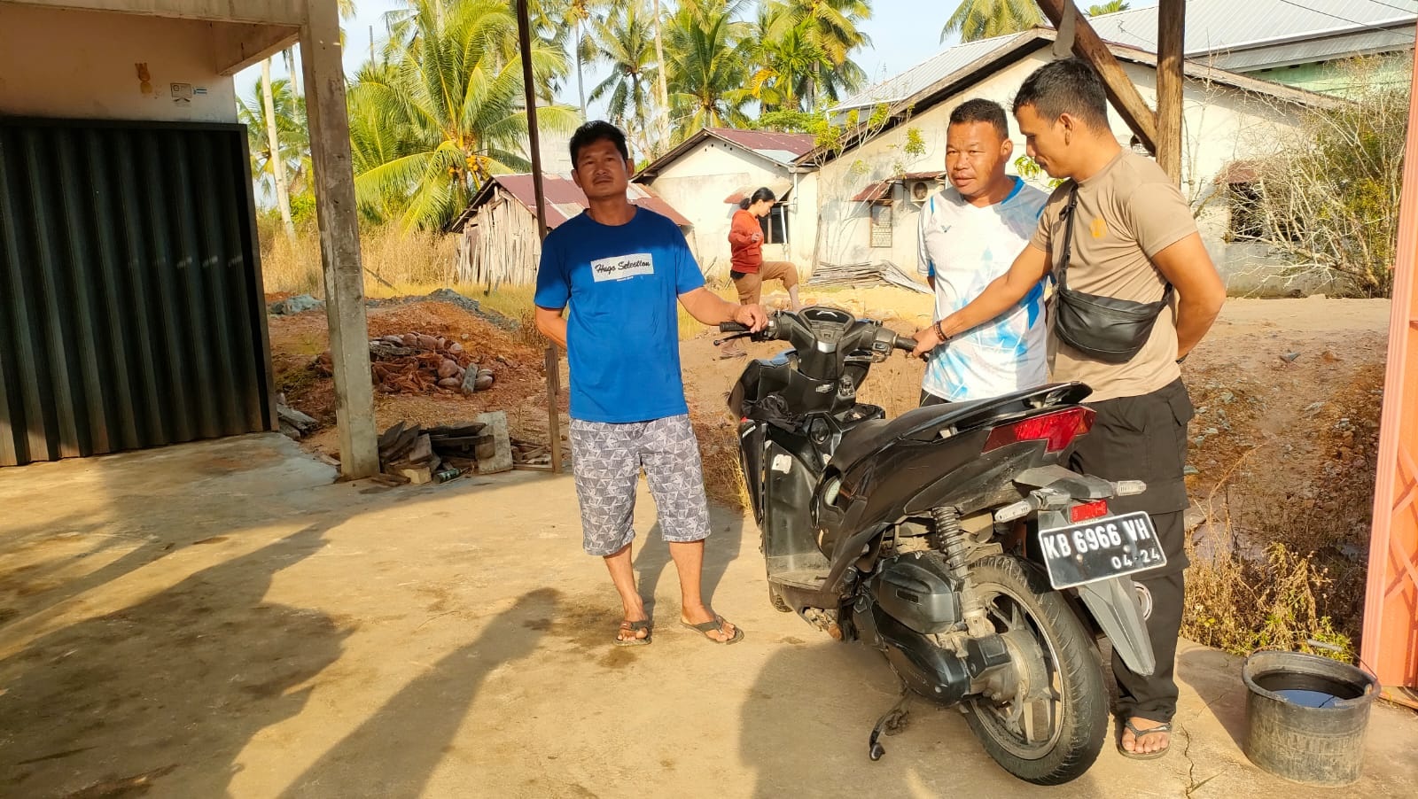 MEMERIKSA: Polisi saat memeriksa sepeda motor yang ditinggalkan di depan bengkel.