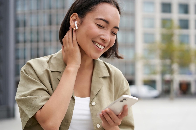 Ilustrasi seorang wanita menggunakan earphone.