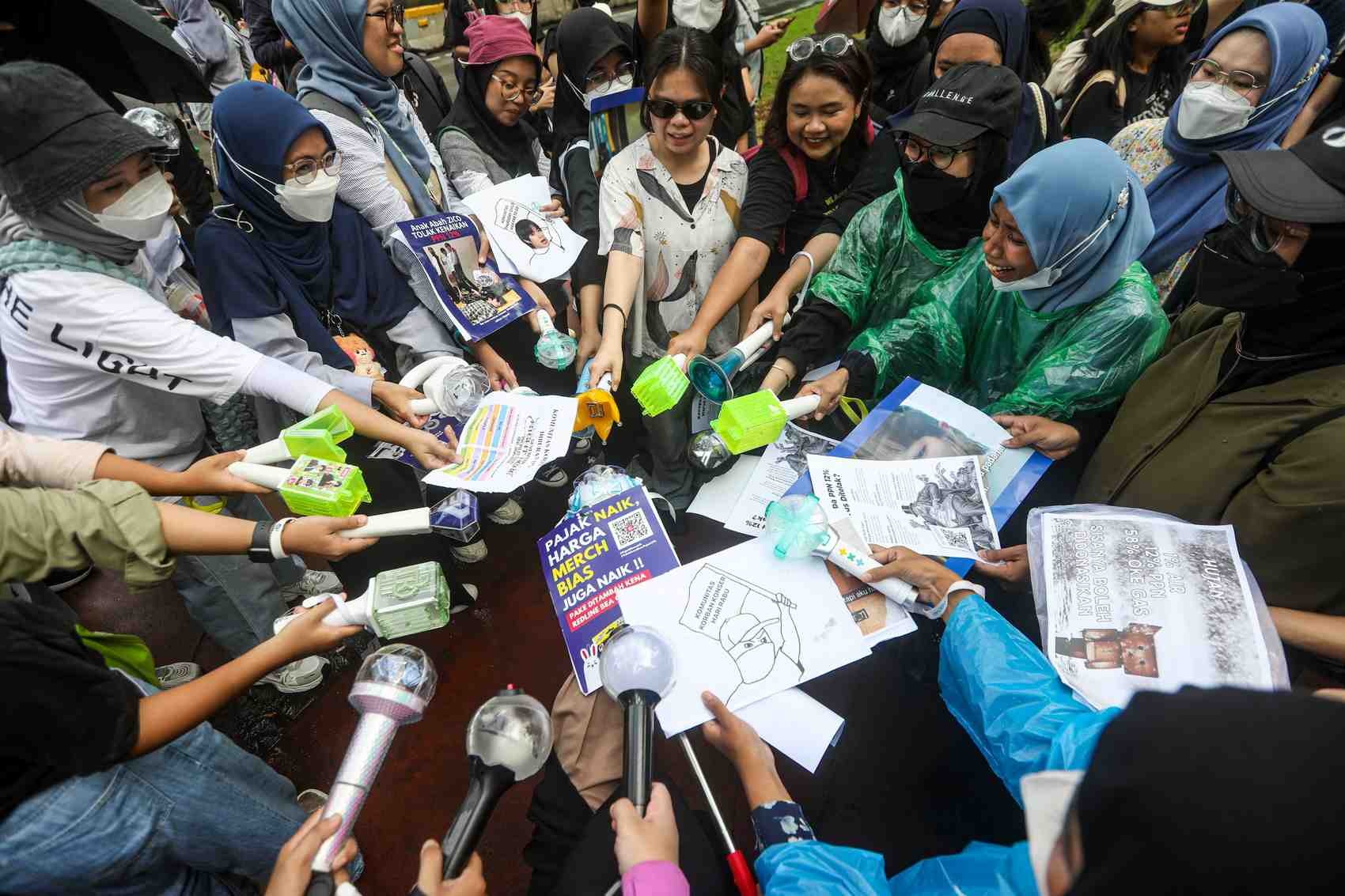 UNJUK RASA: Para K-Popers membawa atribut berupa poster, lightstick hingga spanduk dalam aksi tolak PPN 12 persen di depan Istana Negara, Jakarta, Kamis (19/12).