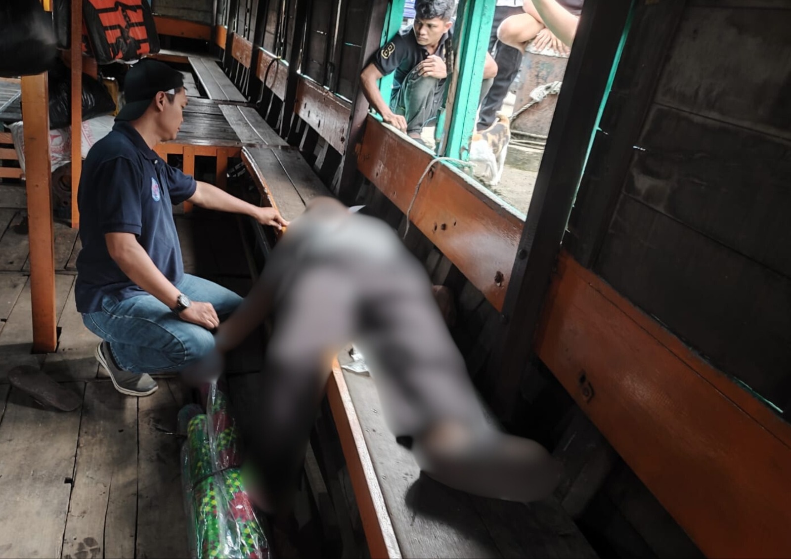 MENINGGAL: Polisi saat memeriksa jenazah nelayan di atas kapal motor di TPI Sungai Kakap, Rabu (8/1).