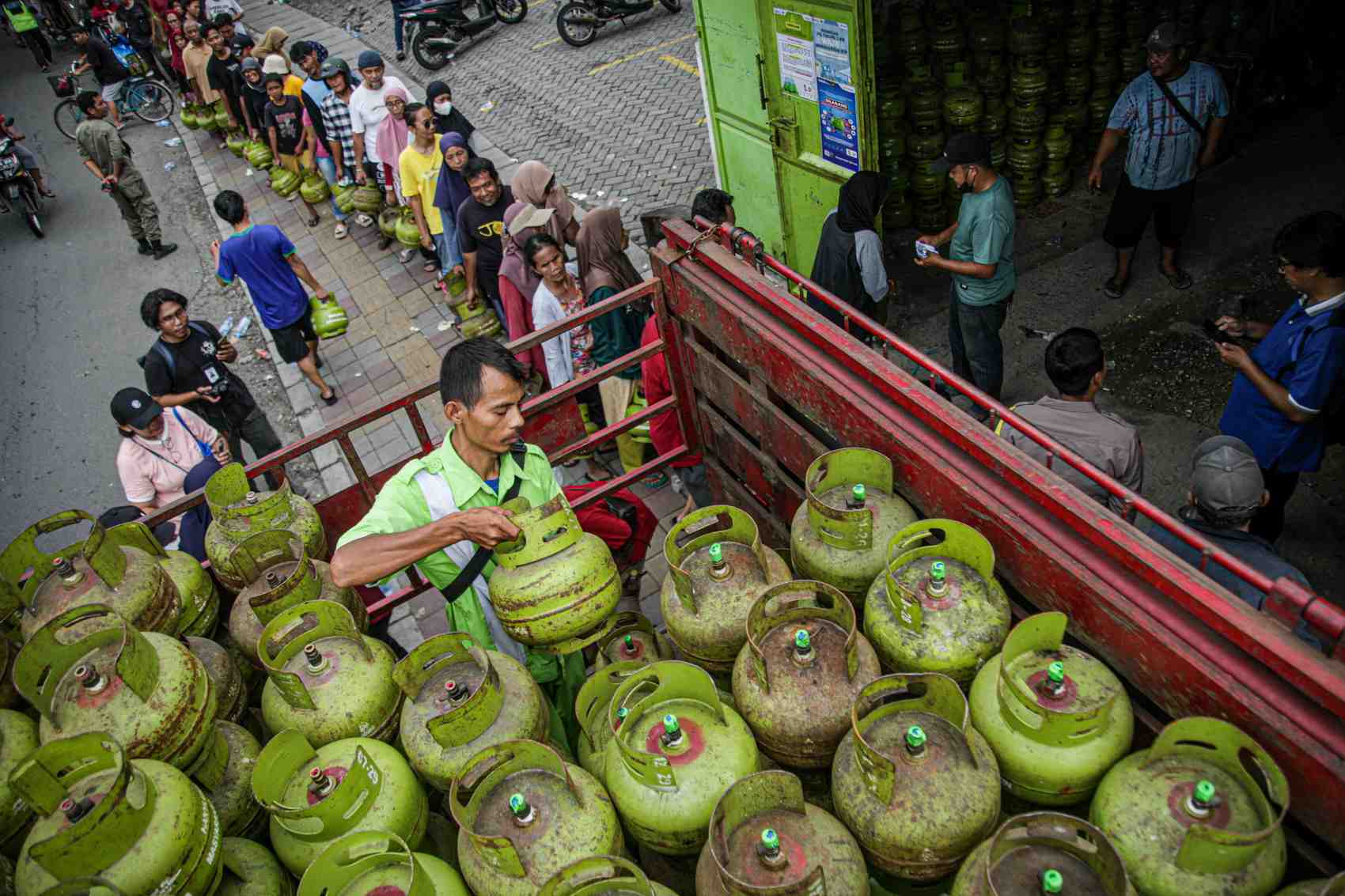 Petugas melayani warga yang sedang mengantre untuk mendapatkan gas elpiji 3 kilogram di Tangerang, Banten, kemarin. Gas elpiji melon kini dilarang dijual di tingkat eceran.