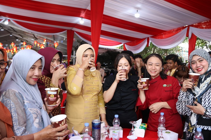 REKOR MURI: Windy Prihastari Harisson saat menikmati kopi campur durian ketika kegiatan pemecahan rekor MURI untuk kategori minum kopi pancong dengan campuran durian.