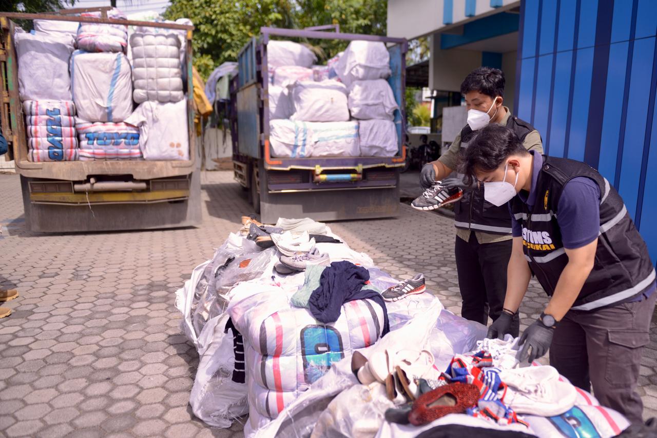 Petugas Bea Cukai saat merapikan barang bukti berupa pakaian bekas ilegal asal Malaysia yang berhasil diamankan oleh tim gabungan di perbatasan Indonesia-Malaysia, Senin (20/2/2025).