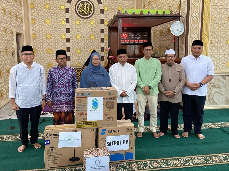 Bupati Erlina menyerahkan sejumlah bantuan untuk pengurus masjid.