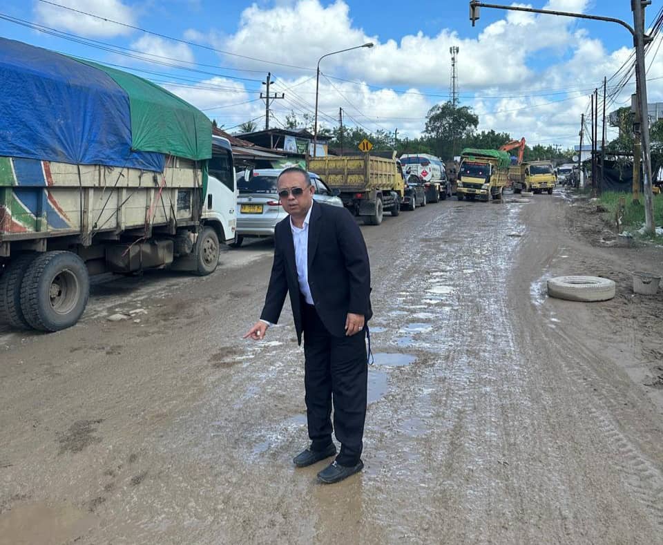 RUSAK : Wowon menunjukkan kondisi jalan rusak di sekitar pergantian jembatan di Jalan Sungai Burung.