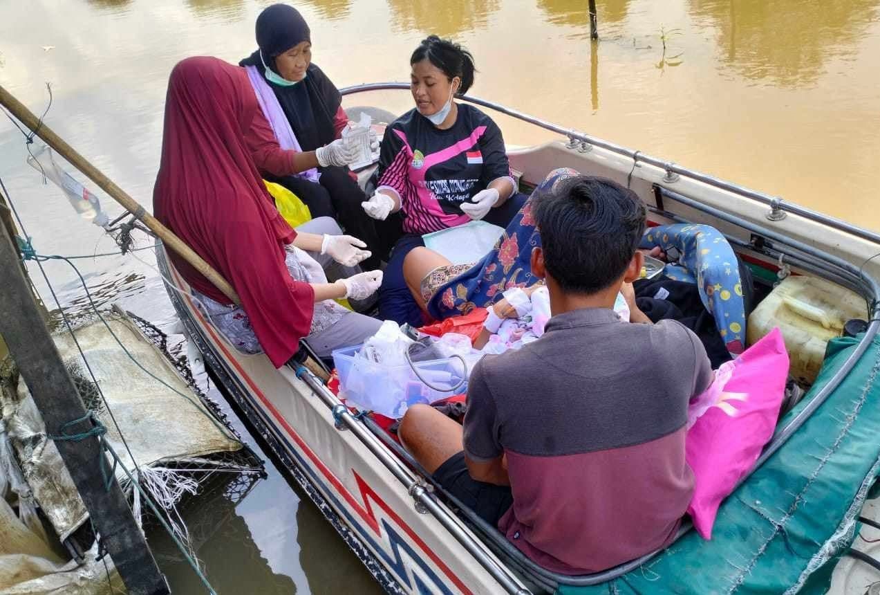 MELAHIRKAN: Bidan dan perawat membantu proses melahirkan seorang perempuan di dalam kapal cepat di Kecamatan Manis Mata, Jumat (11/4) lalu.