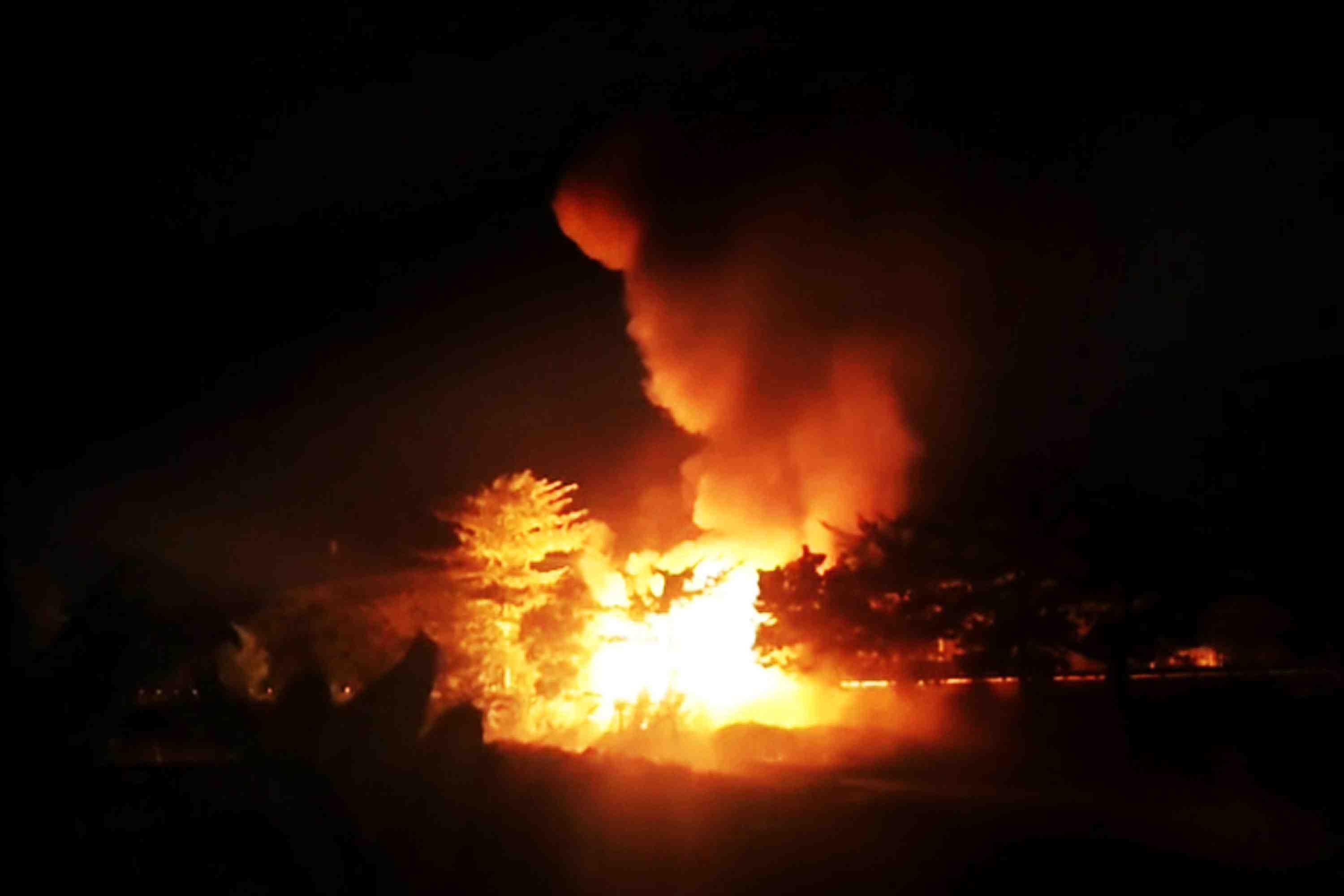 KEBAKARAN: Truk amunisi TNI yang terbakar dan meledak, Senin (5/5) malam.