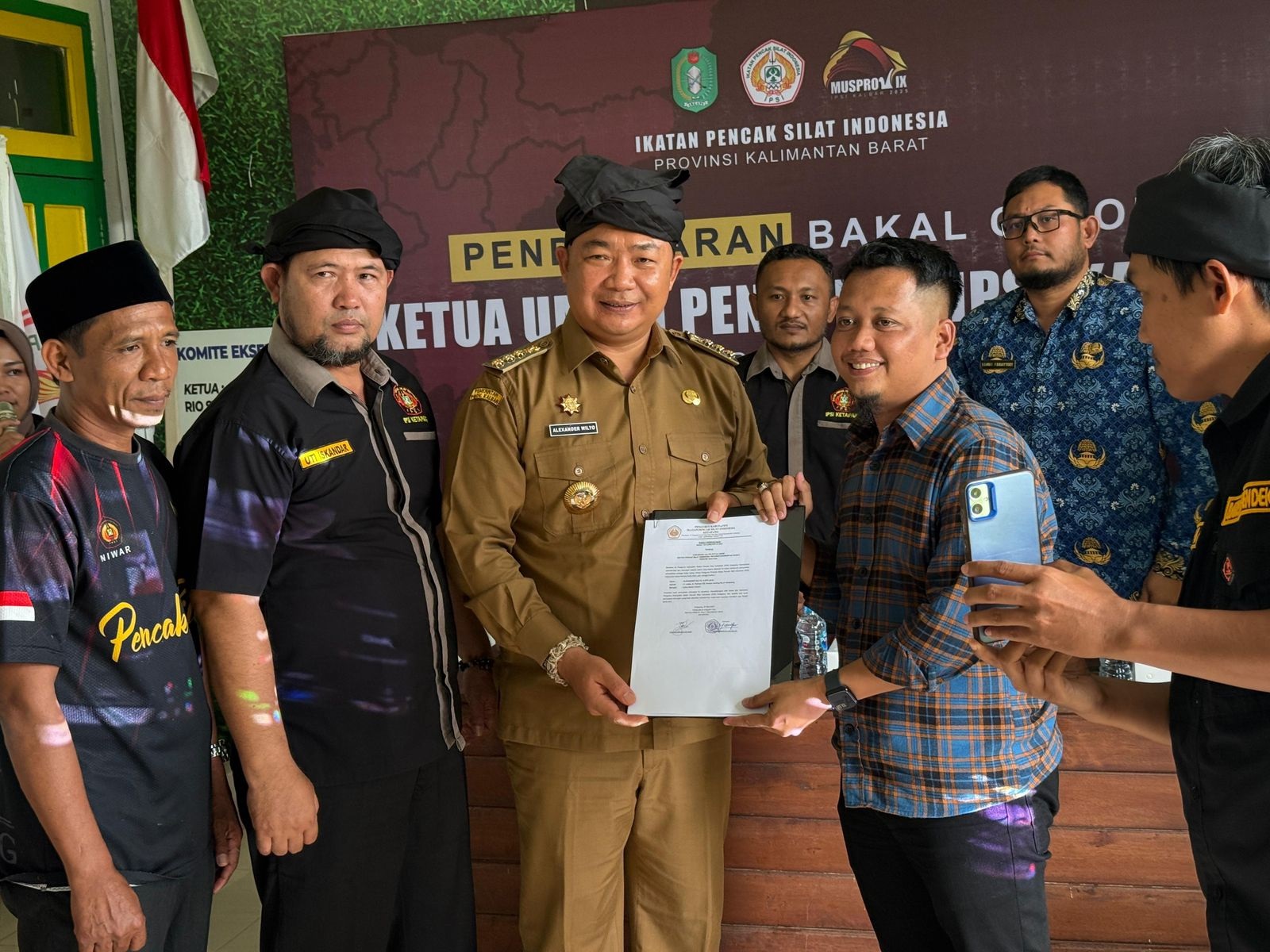 MENDAFTAR: Ketua Panitia Musprov IX IPSI Kalbar, Theo Bernadhi, menerima berkas pendaftaran dari Alexander Wilyo, Senin (2/6).
