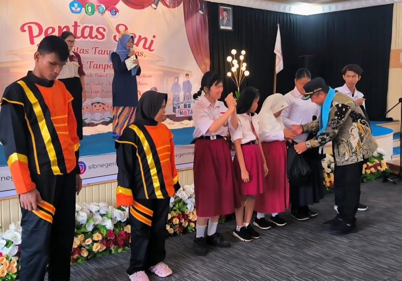Safruddin Asra memberikan penghargaan kepada peserta pentas seni SLB.