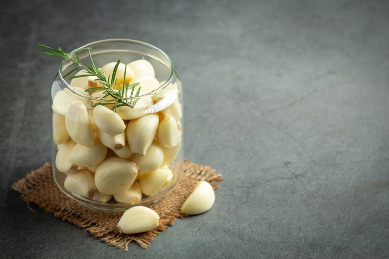 Ilustrasi cara menyimpa bawang putih yang sudah dikupas agar tidak cepat busuk dan tahan lama berbulan-bulan.