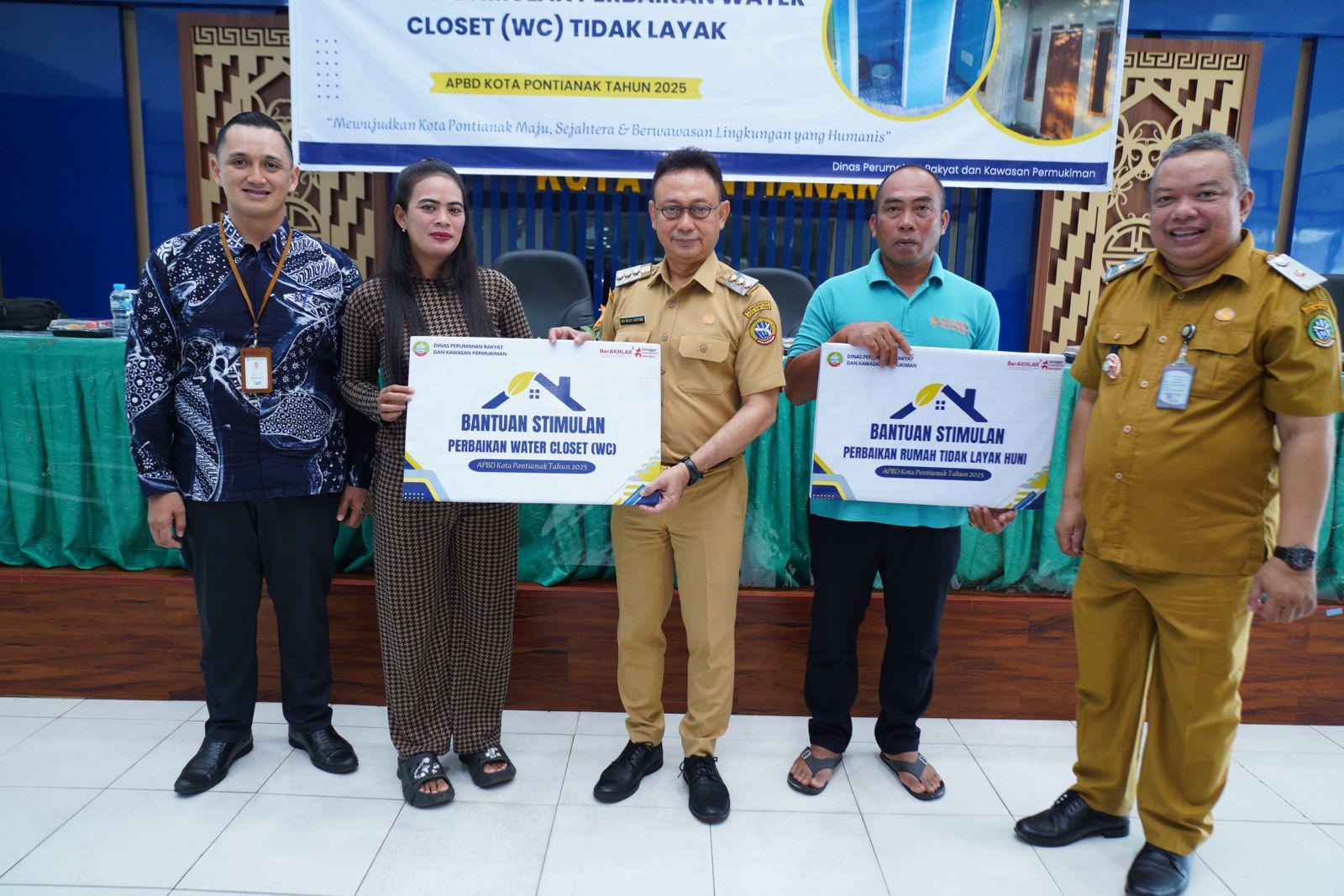 BANTUAN: Wali Kota Pontianak Edi Rusdi Kamtono menyerahkan secara simbolis bantuan stimulan perbaikan RTLH dan WC kepada warga penerima manfaat.
