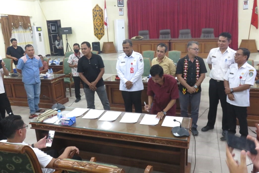 Sejumlah pihak yang bersengketa saat menandatangani kesepakatan yang difasilitasi Pemda Kabupaten Landak di ruang rapat DPRD Kabupaten Landak.