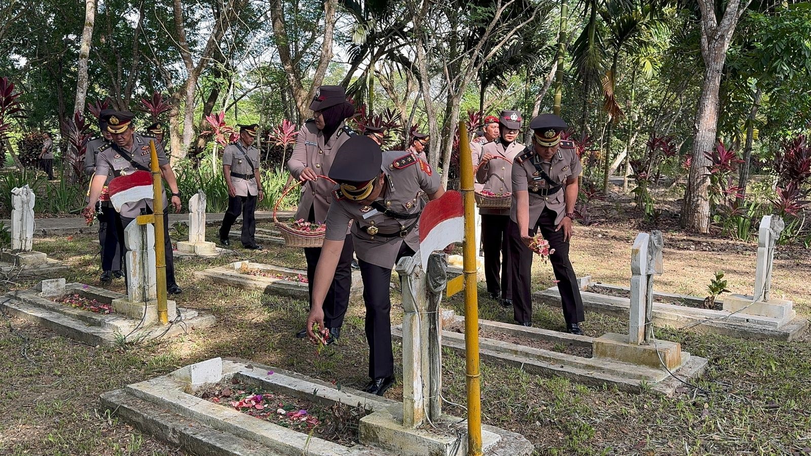 PENGHORMATAN: Kapolres Sambas saat pimpin ziarah makam pahlawan dalam rangka peringatan HUT Bhayangkara.