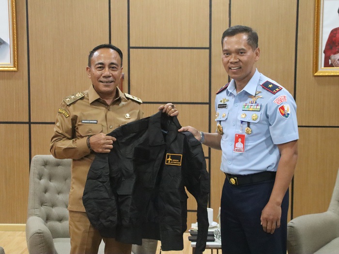 JAKET: Komandan Lanud Supadio TNI AU memberikan jaket kepada Wakil Gubernur Kalbar Krisantus Kurniawan.