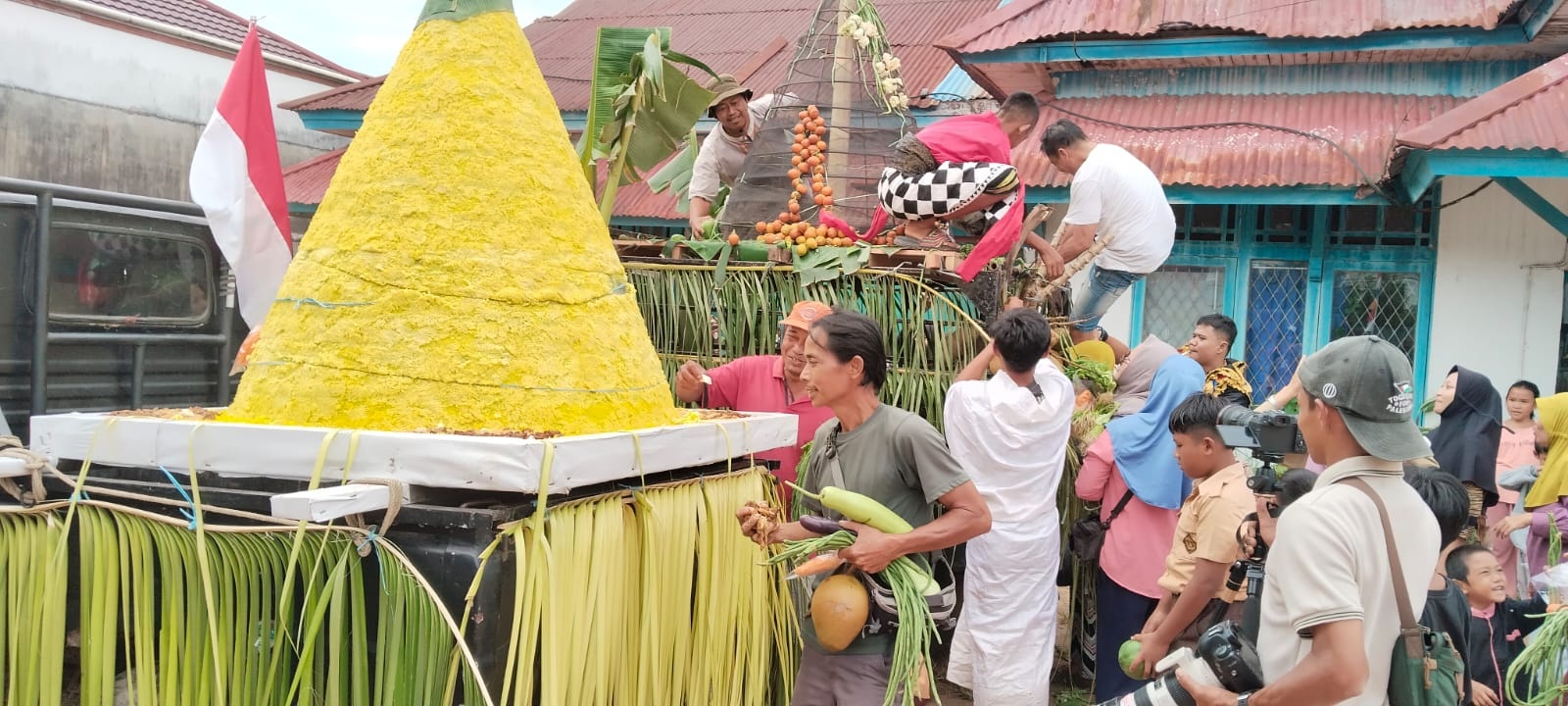 GREBEG SURO: Antusiasme warga saat berebut naik ke atas gunungan sayur saat Grebeg Suro di Kabupaten Melawi untuk mendapatkan bagian tumpeng yang diyakini membawa keberkahan.