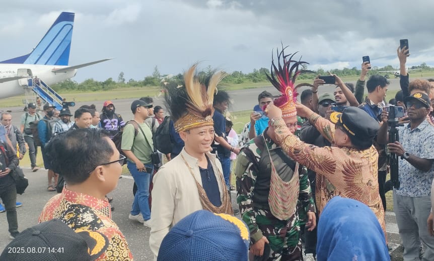 Penyambutan rombongan Kementerian PUPR dan Satgas Kopasgat dengan tarian serta pemasangan mahkota adat di Bandara Yahukimo.