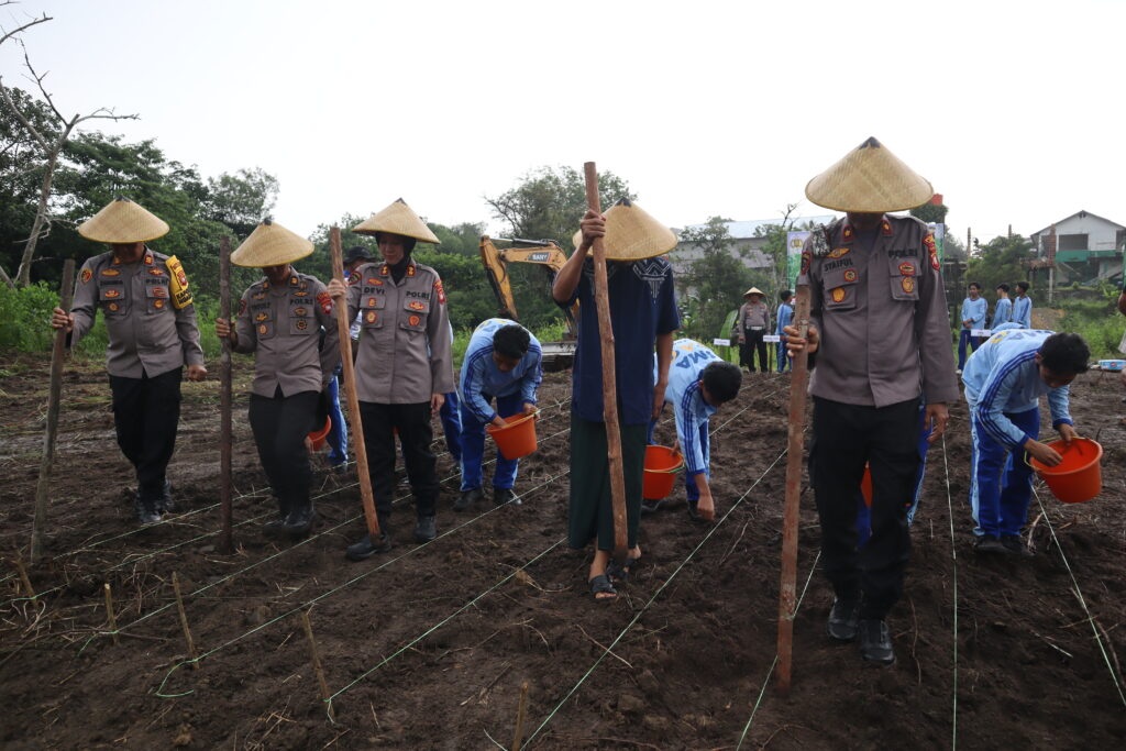 TANAM JAGUNG: Kapolres Landak AKBP Devi Ariantari dan jajarannya bersama santri Pondok Pesantren Nurul Islam menanam jagung di lahan pesantren, Jumat (8/8).