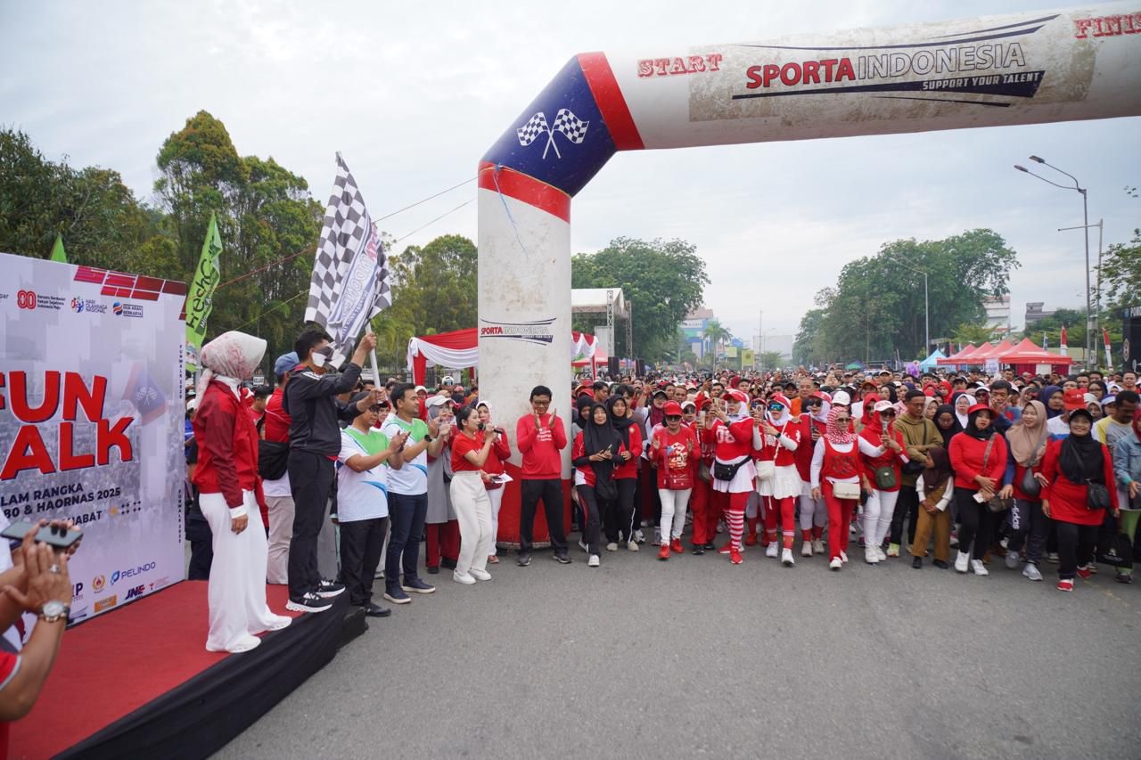 MERIAH: Ribuan masyarakat tumpah ruah mengikuti jalan sehat dalam rangka memperingati HUT ke-80 RI sekaligus Haornas di depan Taman Alun-alun Kapuas, Minggu (31/8).