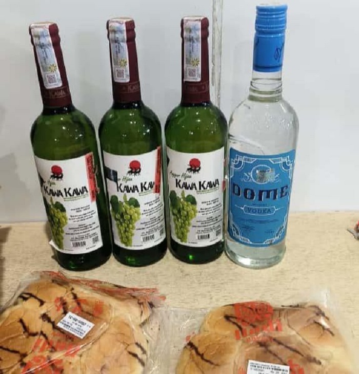 Barang bukti empat botol miras ilegal yang disamarkan dalam kardus roti, diamankan di Bandara Mopah Merauke.