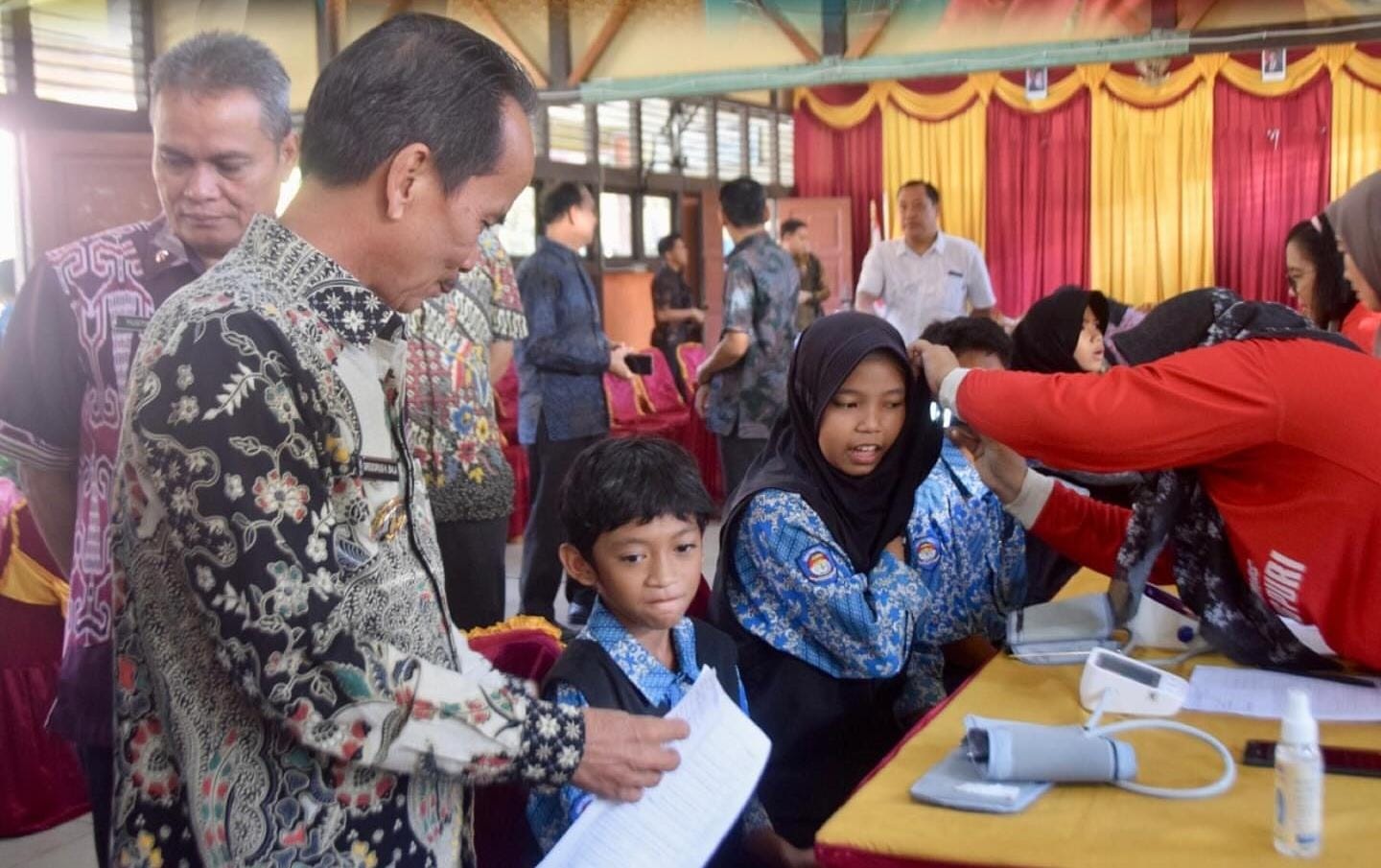BERBINCANG: Bupati Sintang Gregorius Herkulanus Bala berbincang dengan seorang siswa saat meninjau program Cek Kesehatan Gratis bagi siswa SMP Negeri 1 Sintang, Jumat (3/10).