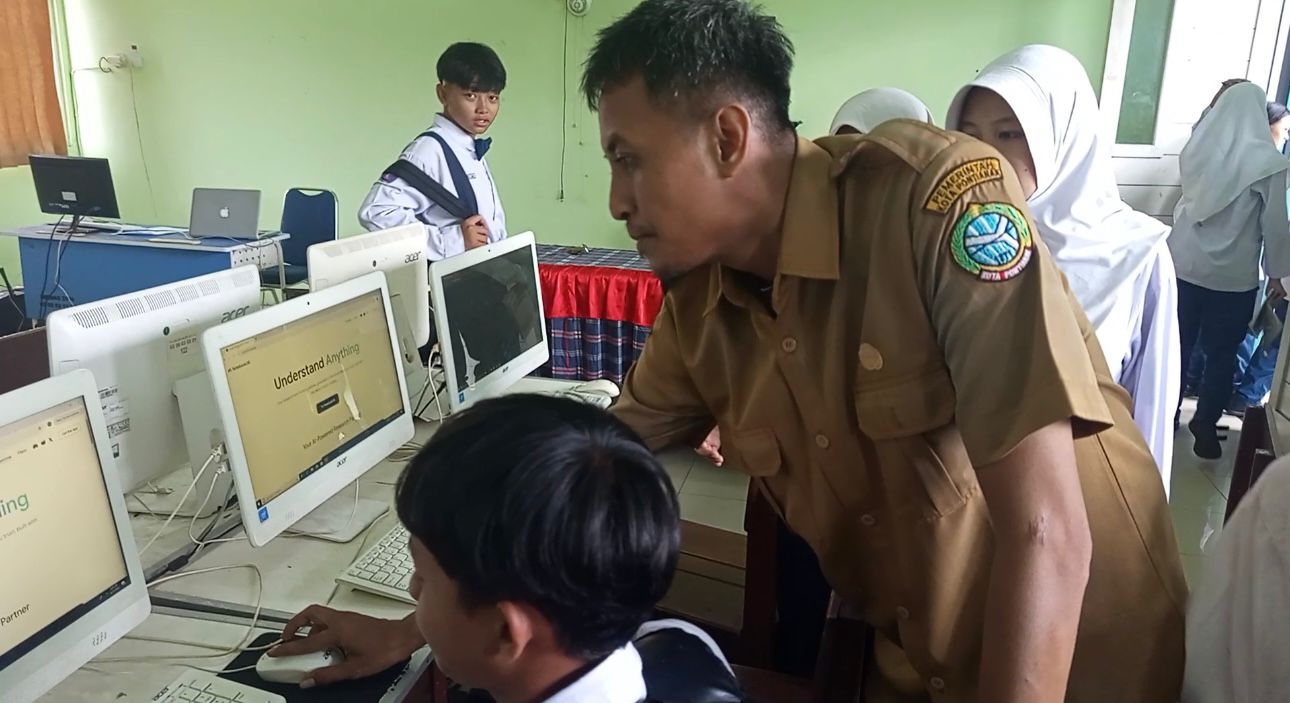 MENGAJAR: Guru SMPN 13 Rahmat Putra Yudha tengah mengajarkan siswa menggunakan AI dalam belajar Bahasa Inggris.