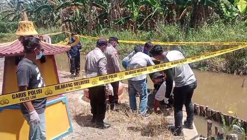 Pihak kepolisian saat evakuasi mayat yang ditemukan di saluran parit.