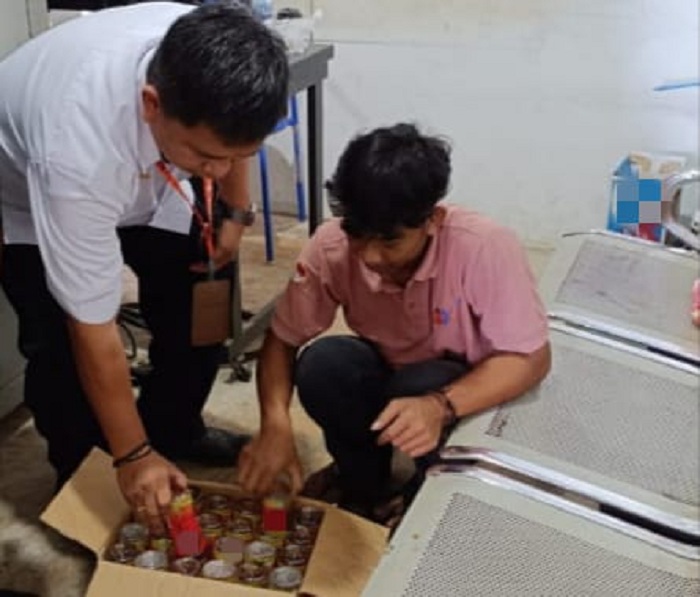 Petugas Bandara Douw Aturure Nabire memeriksa paket mencurigakan yang berisi minuman keras ilegal disamarkan dalam kemasan.