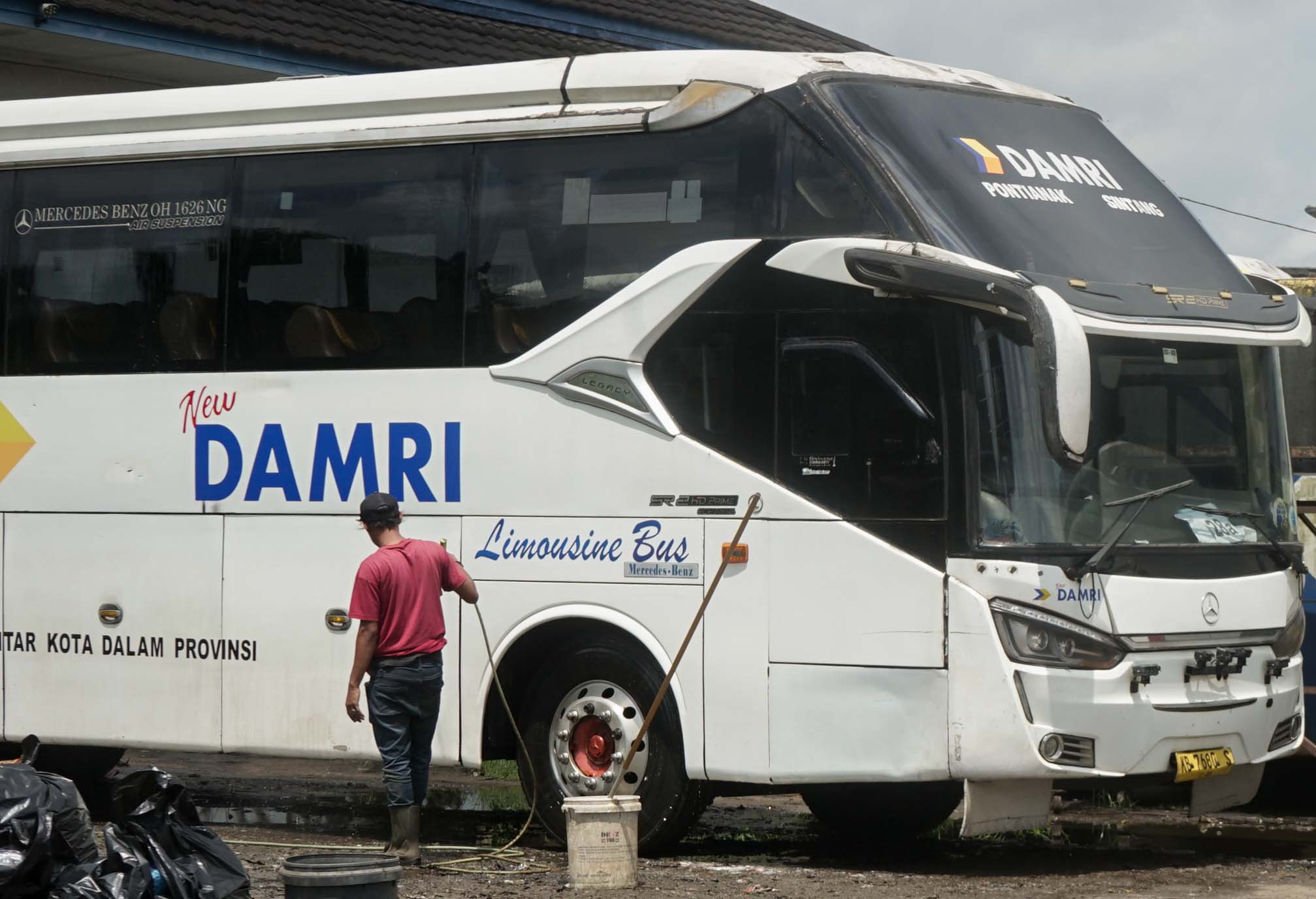 TERDAMPAK: Petugas melakukan perawatan armada bus DAMRI di Terminal Antar Lintas Batas Negara, Jalan Trans Kalimantan. Dibukanya kembali jalur penerbangan luar negeri di Bandara Internasional Supadio 