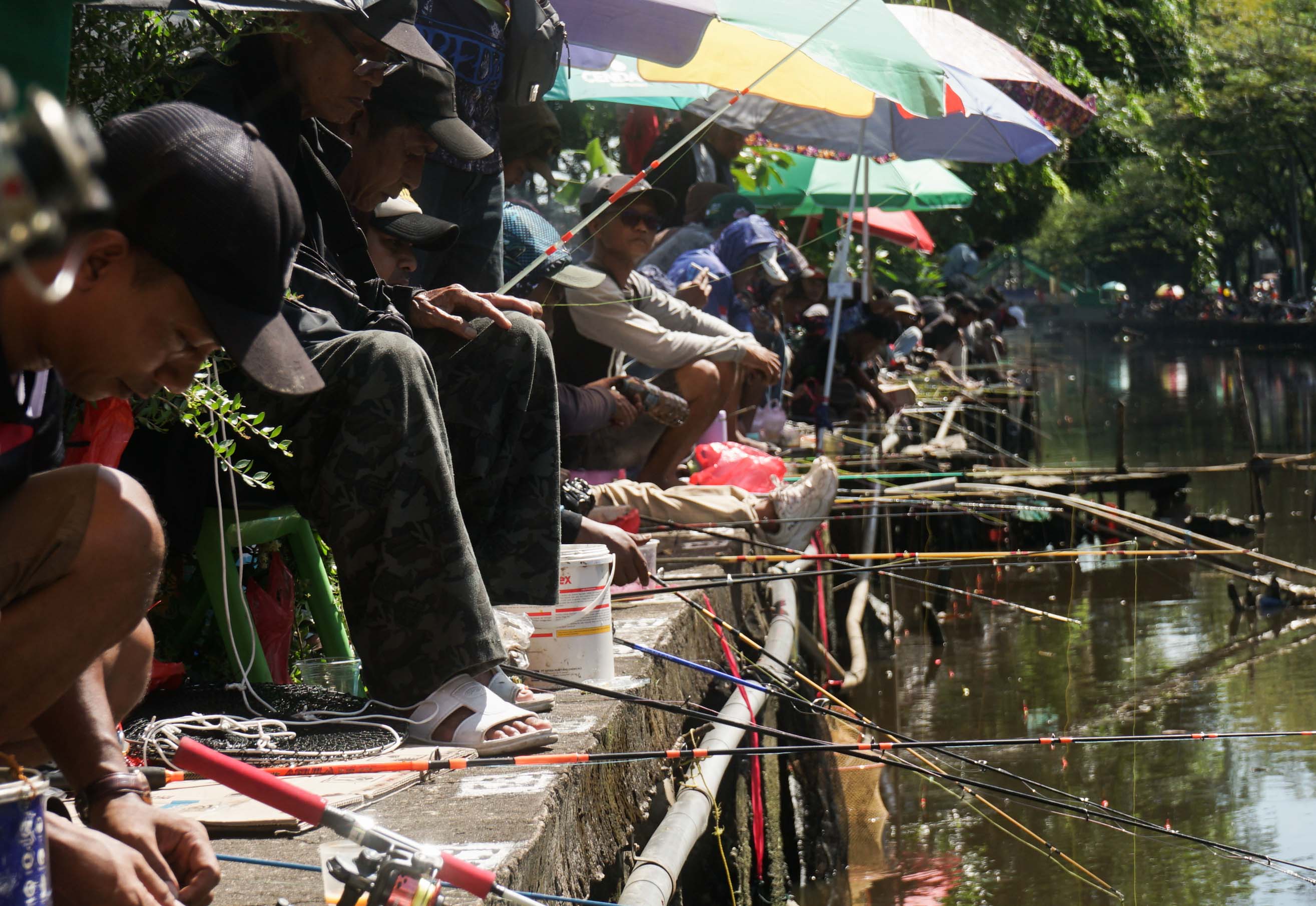 MANCING:Warga mengikuti lomba mancing ikan lele di Sungai Jawi beberapa waktu lalu.