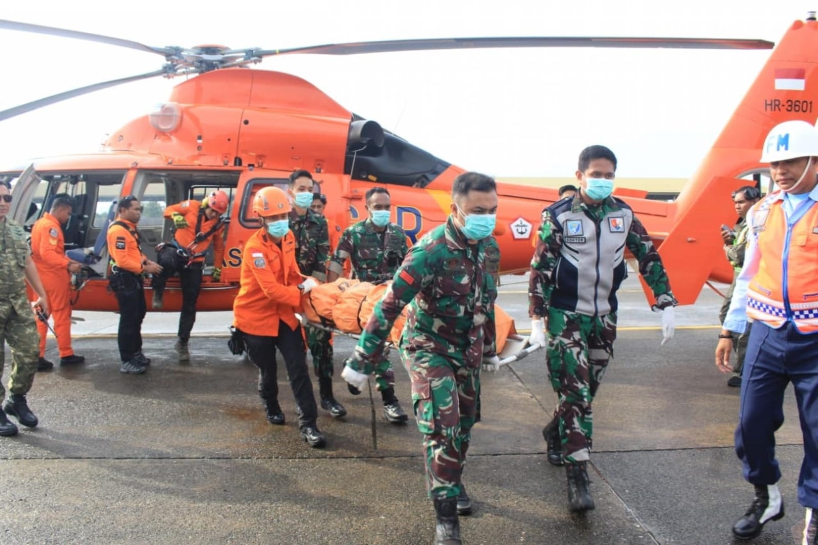 JENAZAH TERAKHIR: Petugas Tim SAR Gabungan menurunkan kantong jenazah terakhir korban kecelakaan pesawat ATR 42-500 setibanya di Pangkalan TNI AU Sultan Hasanuddin, Makassar, Jumat (23/1).