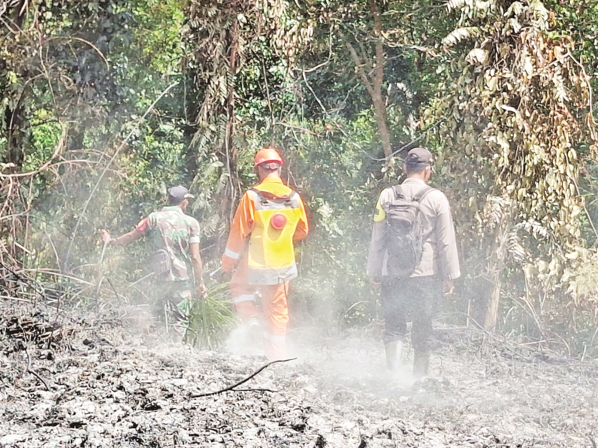 KARHUTLA: Tim gabungan saat melakukan pemadaman Karhutla di wilayah perbatasan Desa Pulau Majang Kecamatan Badau.