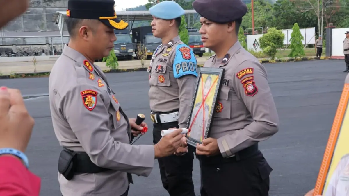 PECAT: Kapolres Kayong Utara AKBP Adi Prabowo mencoret foto dua anggota Polres Kayong Utara saat upacara pemberhentian tidak dengan hormat (PTDH) di halaman Mapolres Kayong Utara, Selasa (7/4). (ISTIMEWA)