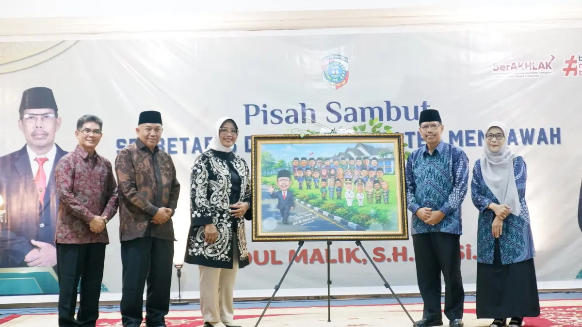 Bupati didampingi Wakil Bupati dan Sekda Mempawah yang baru memberikan cenderamata berupa karikatur kepada Ismail, mantan Sekda yang baru saja purnatugas.