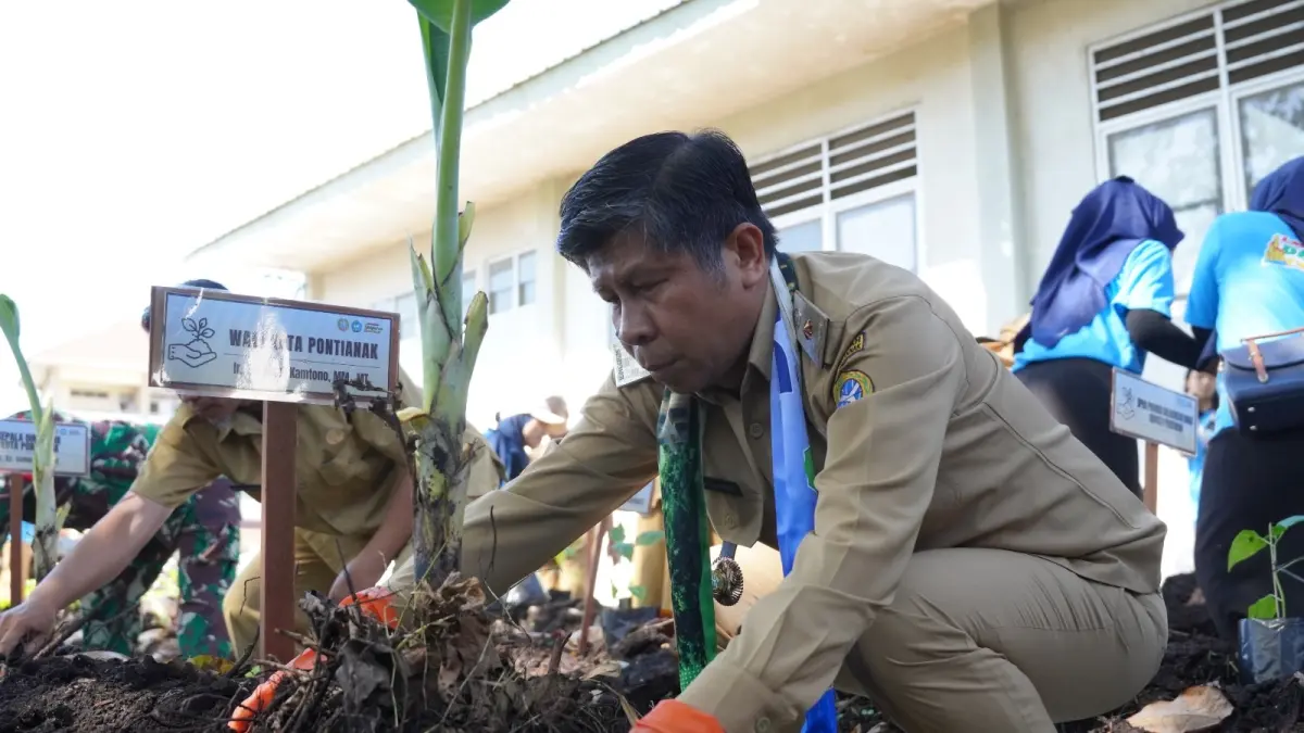 Plh Kepala Dinas Lingkungan Hidup Kota Pontianak Muchammad Yamin menanam pohon secara simbolis. (ISTIMEWA)