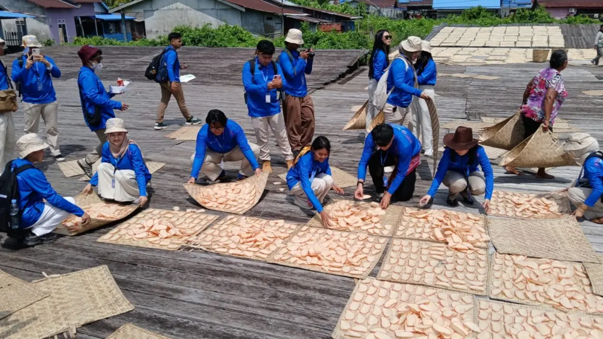 Peserta sedang melihat secara langsung tahapan produksi kerupuk di Sungai Kakap, hingga&nbsp;
membantu pekerja mengangkat kerupuk yang dijemur di halaman rumah produksi (NOVANTAR RAMSES NEGARA/PONTIANAK POST)