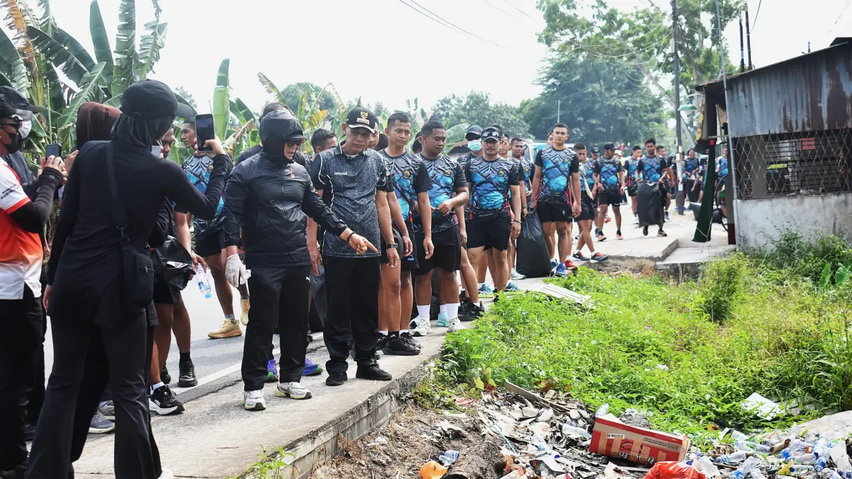 Bupati Kubu Raya H. Sujiwo meninjau kondisi tumpukan sampah di saluran drainase saat mengikuti aksi Clean Up Action bersama prajurit Yon Parako 466 Pasgat, OPD, TNI-Polri, dan masyarakat di Rasau Jaya, Minggu (26/7).