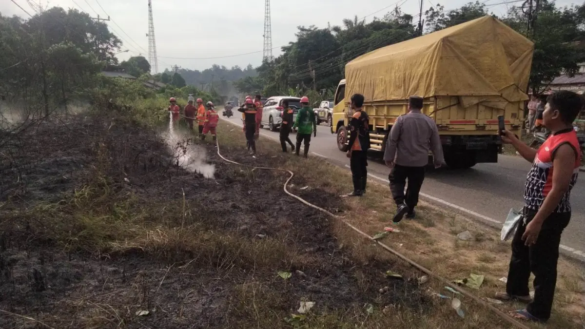 Personel Polsek Kapuas bersama tim gabungan memadamkan kebakaran lahan di Dusun Penyeladi, Kecamatan Kapuas, Kabupaten Sanggau, Sabtu (25/7/2026).