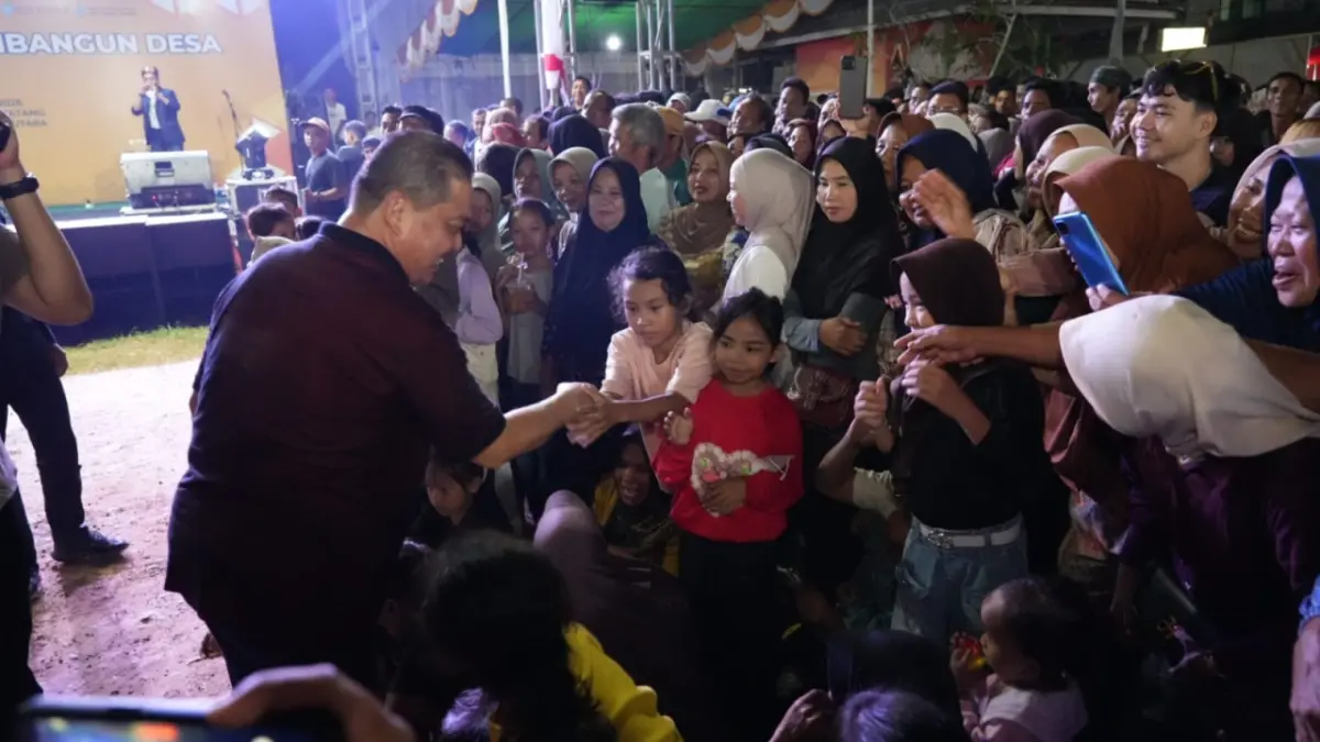 Gubernur Kalimantan Barat Ria Norsan menyalami warga yang datang menyaksikan malam hiburan rakyat yang menjadi puncak rangkaian Gema Membangun Desa di Teluk Batang pada Jumat (31/7) malam. (ADPIM PEMPROV KALBAR)