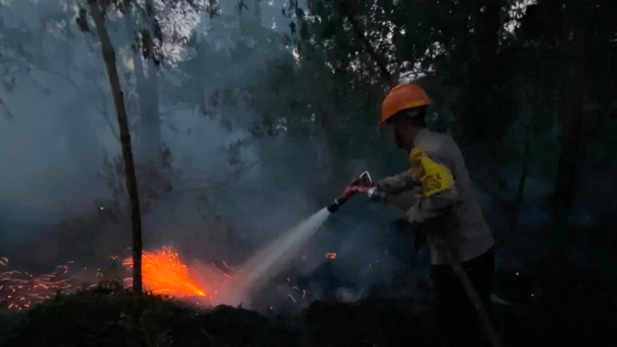 CEGAH MEREMBET: Personel Tim Siaga Karhutla Satbrimob Polda Kalbar memadamkan kebakaran lahan di Desa Arang Limbung, Kecamatan Sungai Raya, Kabupaten Kubu Raya, Kamis (6/8). Api yang hanya berjarak sekitar 10 meter dari permukiman warga berhasil dikendalikan sebelum merembet ke rumah-rumah penduduk.