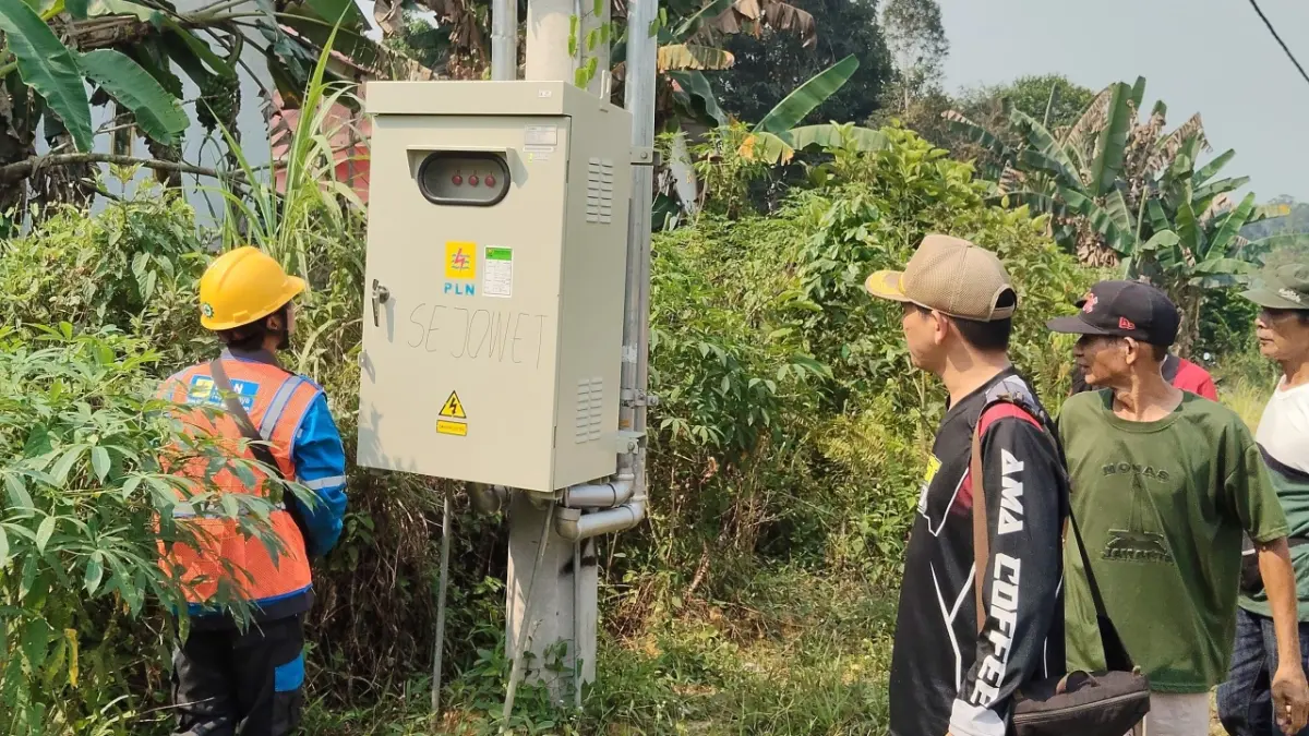 Kades Sejowet Siel memperlihatkan deretan tiang listrik yang telah terpasang di desanya kini telah dialiri listrik pada Kamis (6/8) lalu. (ISTIMEWA)