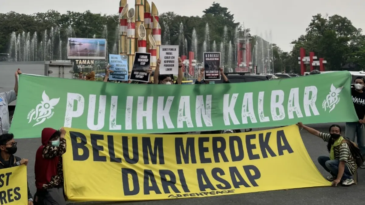 Peserta aksi Aliansi Darurat Asap membentangkan spanduk bertuliskan “Kalimantan Barat Belum Merdeka Asap” di depan Tugu Digulis, Pontianak, Jumat (14/8/2026), sebagai bentuk protes terhadap karhutla dan kabut asap yang kembali mengancam masyarakat.