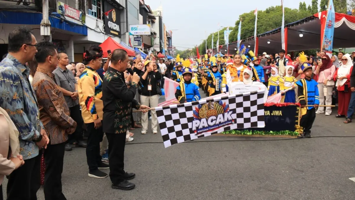 Gubernur Kalimantan Barat Ria Norsan mengibarkan bendera start dalam Pontianak Carnaval Khatulistiwa (PACAK) dan Carnaval-Parade Drumband se-Kalimantan Barat yang digelar di Jalan Diponegoro, Minggu (16/7). (ADPIM PEMPROV)