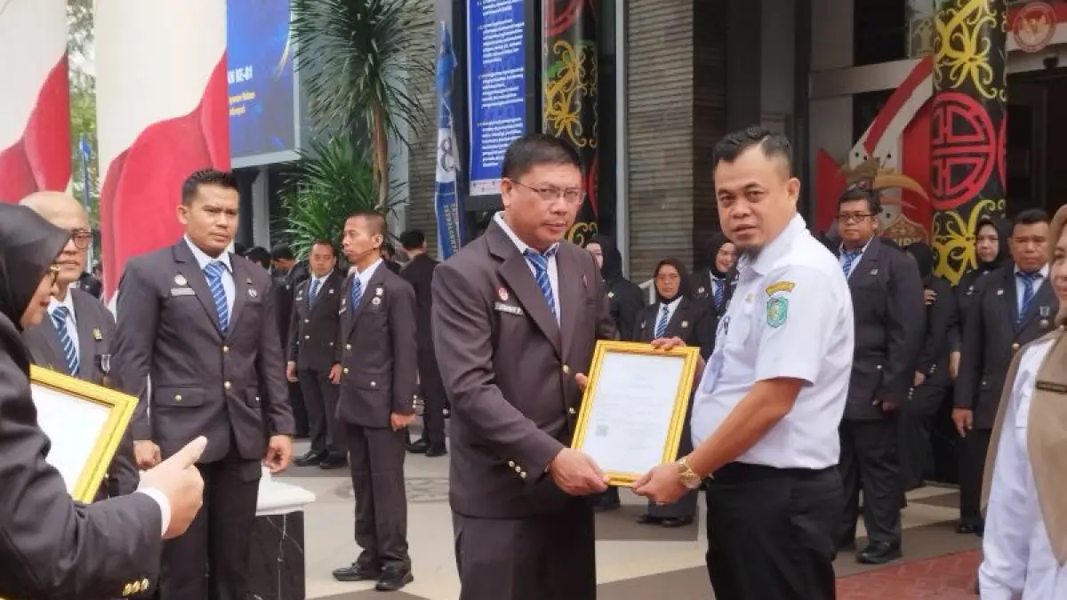 Plt. Kadisbunnak Kalbar, Rino Anteno Tengo (kanan) menyerahkan sertifikat dalam rangkaian Peringatan Hari Pengayoman ke-81 Tahun 2026, Rabu (19/8/2026) di Halaman Kantor Wilayah Kementerian Hukum Kalbar. (ANTARA/Dedi)
