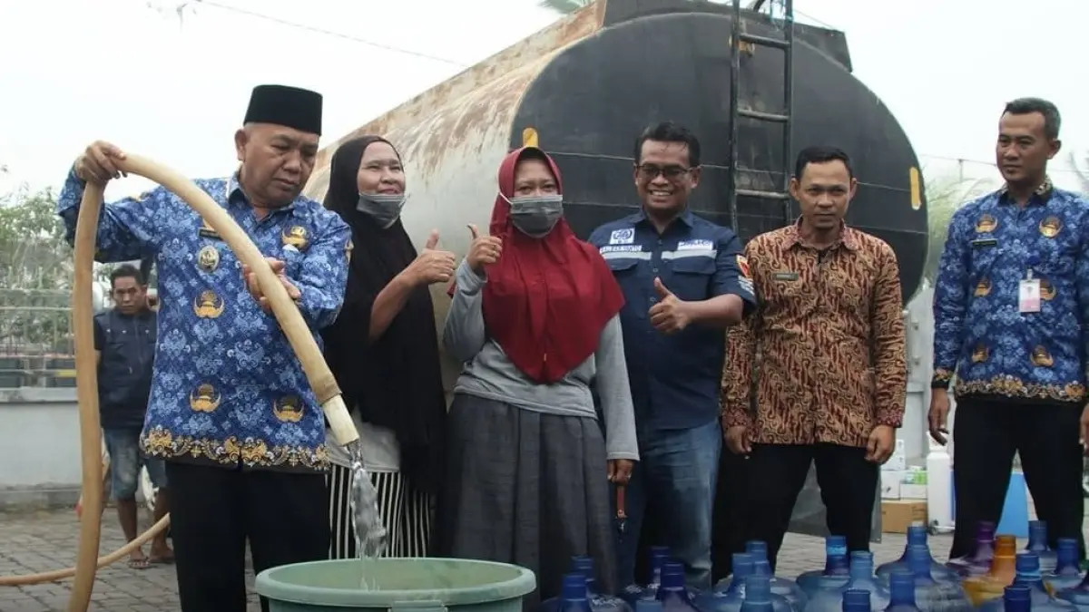 Wabup Mempawah, Juli Suryadi saat membantu masyarakat menyalurkan air bersih