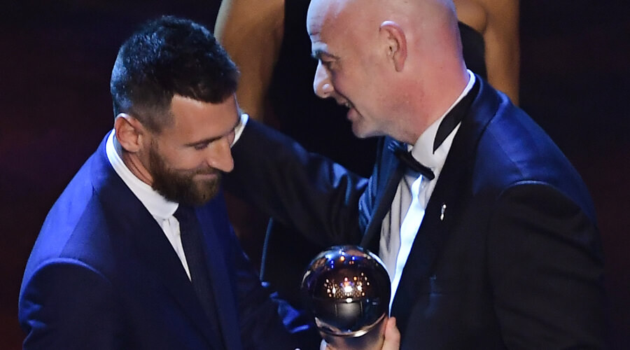 Argentina and Barcelona forward Lionel Messi (L) is presented by FIFA President Gianni Infantino (R) with the trophy for the Best FIFA Men